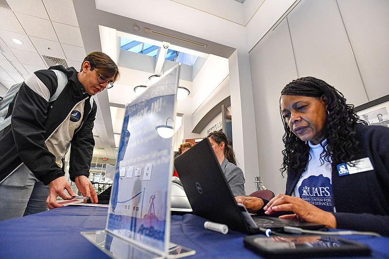 Ivan Welborn (from left), a junior at the University of Arkansas-Fort Smith, checks in with Stephany Dobbins with administration and career services and Jeanette Henry, a coordinator for the Babb Center for Career Services, Thursday, March 9, 2023, at an all-majors career fair hosted by UAFS inside the Reynolds Room of its Smith-Pendergraft Campus Center in Fort Smith. The event offered students an opportunity to speak about career opportunities with nearly 50 employers representing a wide range of fields. Visit nwaonline.com/photo for today's photo gallery.
(NWA Democrat-Gazette/Hank Layton)