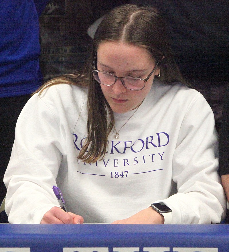 Russellville senior Cameron Grayson signs her letter of intent to play basketball for Rockford University this fall. (Democrat photo/Evan Holmes)