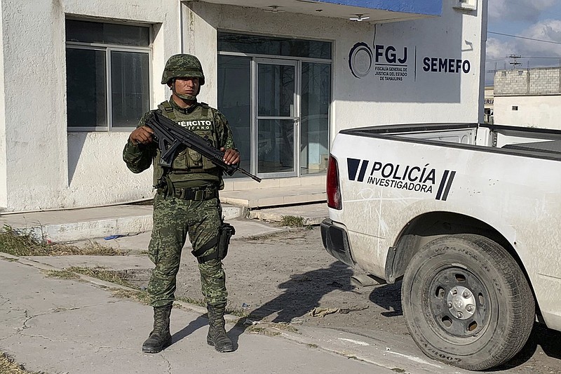 A Mexican army soldier guards the Tamaulipas State Prosecutor's headquarters in Matamoros, Mexico, Wednesday, March 8, 2023. A road trip to Mexico for cosmetic surgery veered violently off course when four Americans were caught in a drug cartel shootout, leaving two dead and two held captive for days in a remote region of the Gulf coast before they were rescued from a wood shack, officials said Tuesday. (AP Photo)
