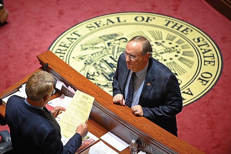 Sen. Mark Johnson (right), R-Little Rock, talks Thursday to Sen. Ricky Hill, R-Cabot, before the start of the Senate session at the state Capitol in Little Rock.
(Arkansas Democrat-Gazette/Staci Vandagriff)