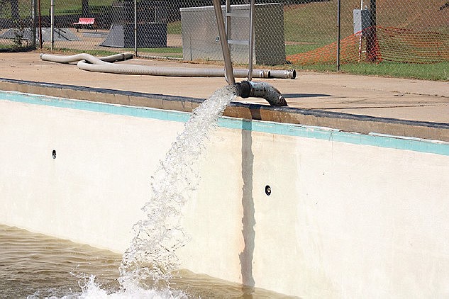 Photo by Michael Hanich
This file photo shows water being pumped into the pool at Carnes Park.
City officials hope to have the opening Memorial Day weekend.