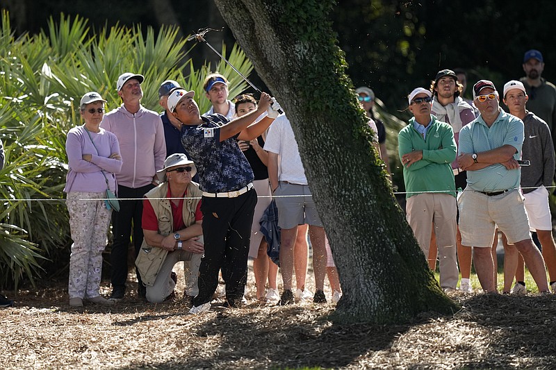 Sungjae Im, of South Korea, hits from behind a tree on the ninth hole during the third round of the Players Championship golf tournament Saturday, March 11, 2023, in Ponte Vedra Beach, Fla. (AP Photo/Eric Gay)
