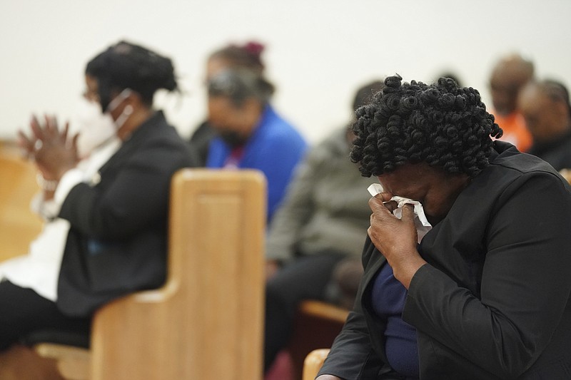 Elder Sharon Hammond uses a tissue during a vigil for a group of Americans recently kidnapped in Mexico, at Word of God Ministries in Scranton, S.C., Wednesday, March 8, 2023. Two of the four Americans, all from South Carolina, were killed after being caught in a deadly shootout while traveling last week to Matamoros for one of them to get cosmetic surgery. (AP Photo/Sean Rayford)
