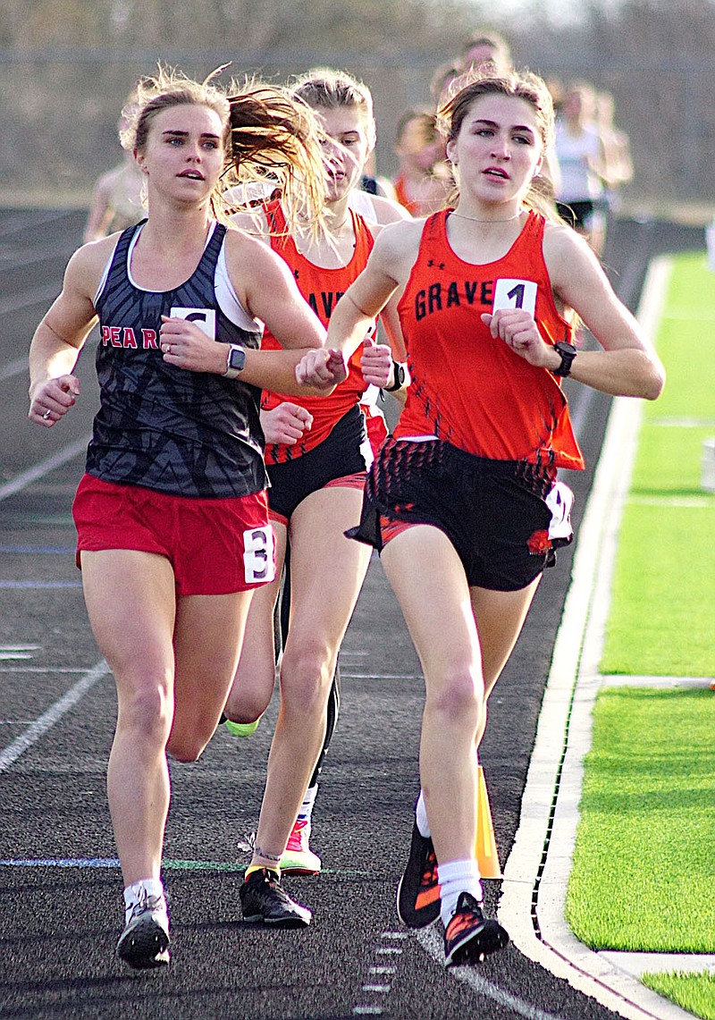 Randy Moll/Westside Eagle Observer
Gravette junior Julia Whorton (right) leads the pack in the third lap of the 1600-meter run at the Gravette Running Festival on Friday. Whorton went on to win the event, as well as the 3200-meter run.
