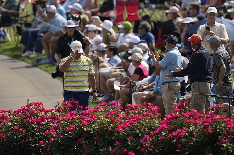 Hideki Matsuyama, of Japan, tips his hat while walking toward the 17th green during the final round of The Players Championship golf tournament, Sunday, March 12, 2023, in Ponte Vedra Beach, Fla. (AP Photo/Eric Gay)