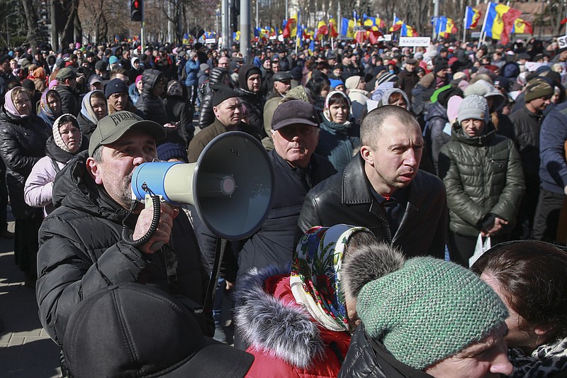 People shout anti-government slogans during a protest initiated by the Movement for the People and members of Moldova's Russia-friendly Shor Party, against the pro-Western government and low living standards, in Chisinau, Moldova, Sunday, March 12, 2023. Moldovan police said on Sunday they have foiled a plot by groups of Russia-backed actors who were specially trained to cause mass unrest during a protest the same day in the capital against the country's new pro-Western government. (AP Photo/Aurel Obreja)