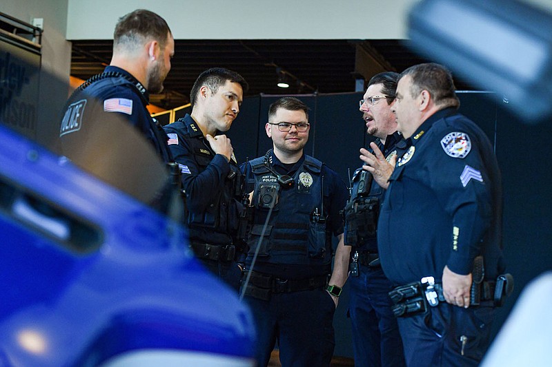 Officers with the Fort Smith Police Department visit during a news conference announcing this year's Steel Horse Rally at Fort Smith Harley-Davidson in Fort Smith. (River Valley Democrat-Gazette/Hank Layton)