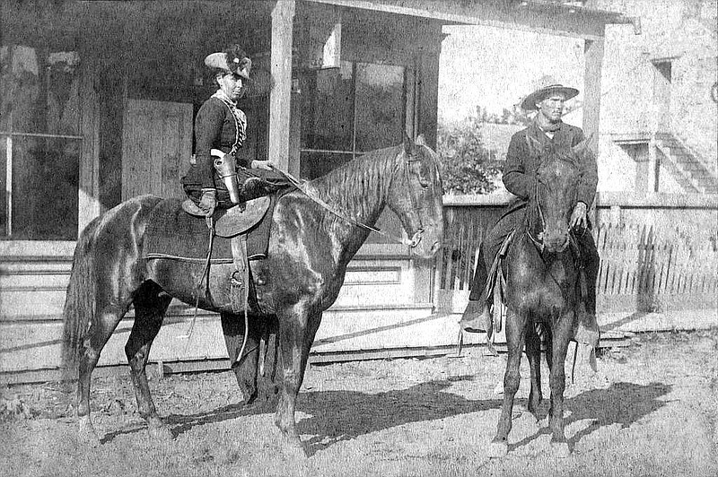 Belle Starr sits side-saddle on her horse at Fort Smith (Sebastian County) in 1886. The man on the horse next to her is Deputy U.S. Marshal Benjamin Tyner Hughes, who — along with his posse man, Deputy U.S. Marshal Charles Barnhill — arrested her at Younger’s Bend in May 1886 and took her to Fort Smith for arraignment. (Public Domain)