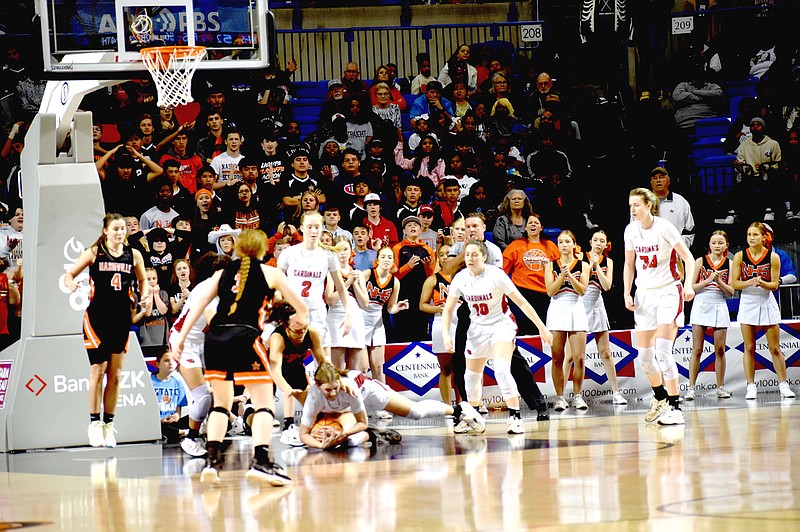 Mark Humphrey/Enterprise-Leader
Farmington sophomore Kaycee McCumber dives on a loose ball at the defensive end of the court. Somehow she managed to pass off to teammate Marin Adams and gain possession for Farmington as the Lady Cardinals won the Class 4A State championship in girls basketball by defeating Nashville, 65-61, in the state finals on Thursday, March 9, 2023, at Bank OZK Arena in Hot Springs.