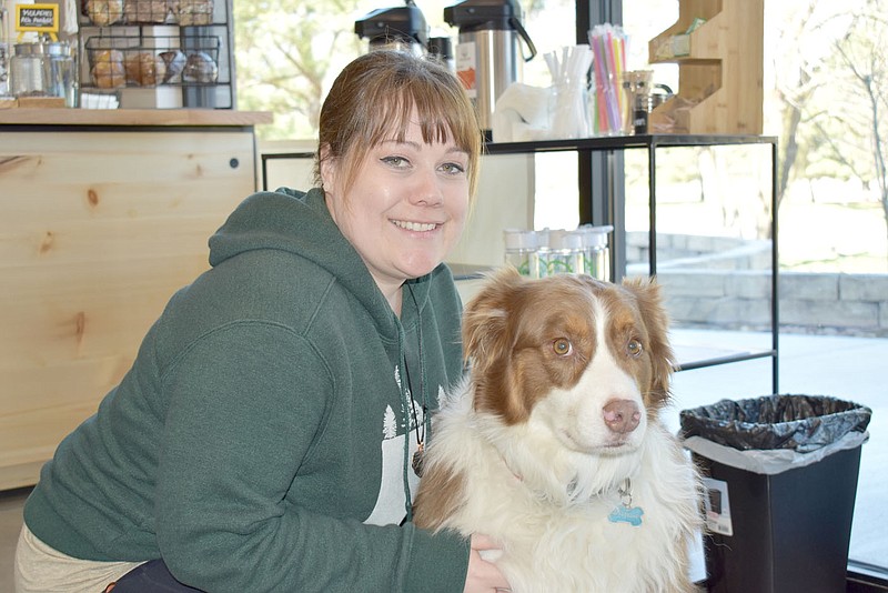 Rachel Dickerson/The Weekly Vista Katie Schneider of Bella Vista is pictured with her Australian Shepherd, Charlie, at her business, Trailside Coffee Company.