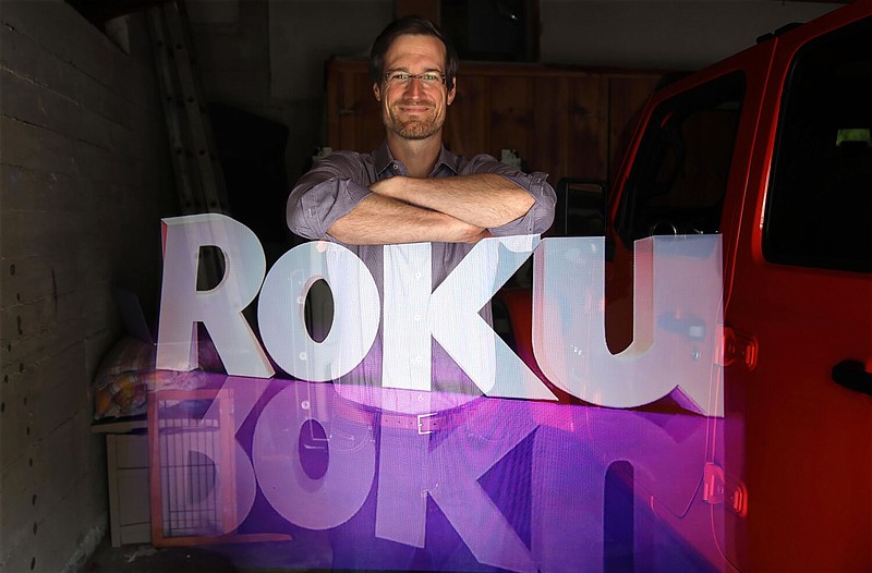 Rob Holmes, vice president of programming and engagement for Roku, stands over the company logo is this double-exposure made at his home in Los Angeles on May 12, 2020. According to a regulatory filing, the company had $487 million, or about a quarter of its cash, saved in Silicon Valley Bank, which failed last week. (Genaro Molina/Los Angeles Times/TNS)