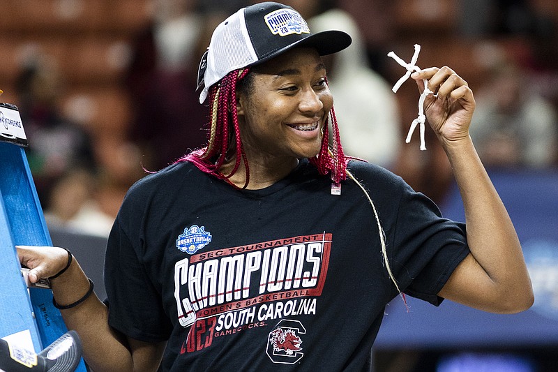 South Carolina's Aliyah Boston holds up her piece of the the net after defeating Tennessee 74-58 to win the championship game of the Southeastern Conference women's tournament in Greenville, S.C., Sunday, March 5, 2023. (AP Photo/Mic Smith)