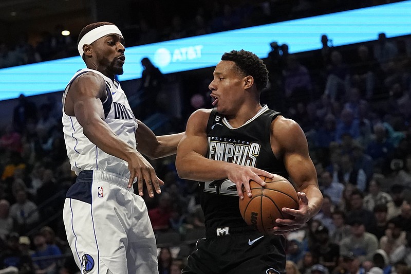 Memphis Grizzlies guard Desmond Bane (22) grabs a rebound against Dallas Mavericks forward Justin Holiday during the first half of an NBA basketball game in Dallas, Monday, March 13, 2023. (AP Photo/LM Otero)