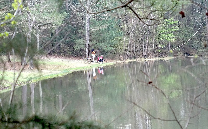 Tucked away in the woods surrounding Atlanta’s Sports Complex is the city’s pond. Here one can walk around its trails or sit on the banks and fish. Not many towns have such a fishing pond inside the city limits. (Photo by Neil Abeles)