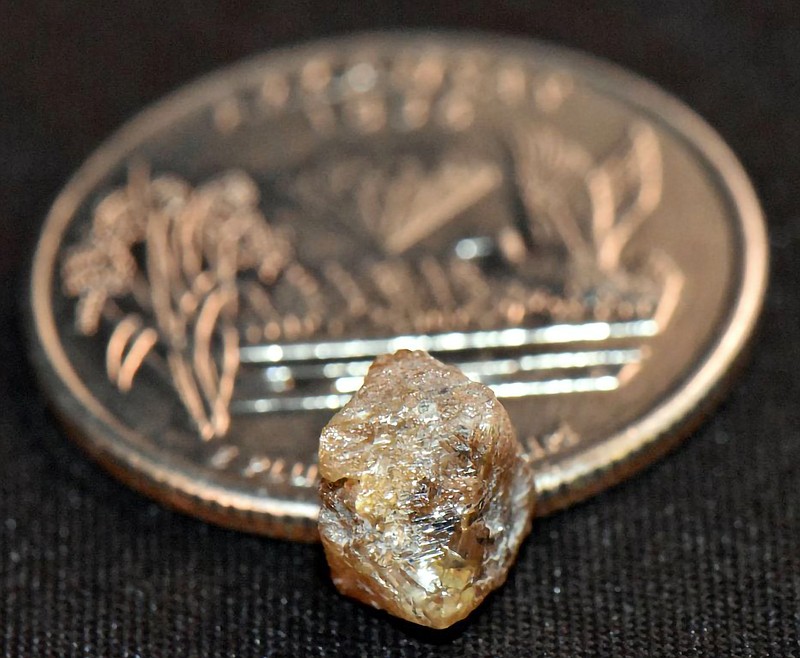 David Anderson of Murfreesboro, Arkansas, found this 3.29-carat diamond — photographed next to a quarter for scale — March 4, 2023, at Crater of Diamonds State Park in Murfreesboro. The diamond was the largest found in the park since September 2021. (Arkansas Parks Department)