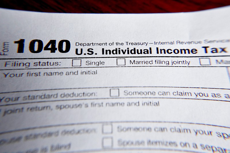 FILE - This Feb. 13, 2019 file photo shows part of a 1040 federal tax form printed from the Internal Revenue Service website, in Zelienople, Pa. It&#x2019;s the first quarter of the year, and many people may be interested in starting side hustles for extra income or to finally pursue their entrepreneurial dreams. Whatever the motivation, it&#x2019;s important to know the implications of starting a side gig while having a 9-to-5 job. This includes understanding how to plan for taxes, budgeting for your side income and deciding how you want your money to work for you. (AP Photo/Keith Srakocic, File)