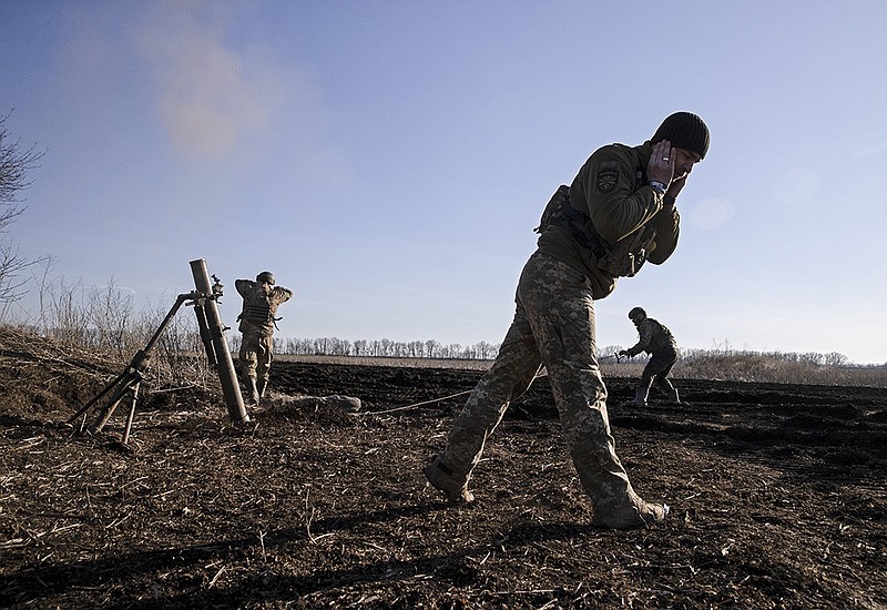 Ukrainian soldiers with the 28th Brigade fire a 120mm mortar from outside Chasiv Yar toward Russian positions near Bakhmut in the Donetsk region of eastern Ukraine, March 14, 2023. (Tyler Hicks/The New York Times)