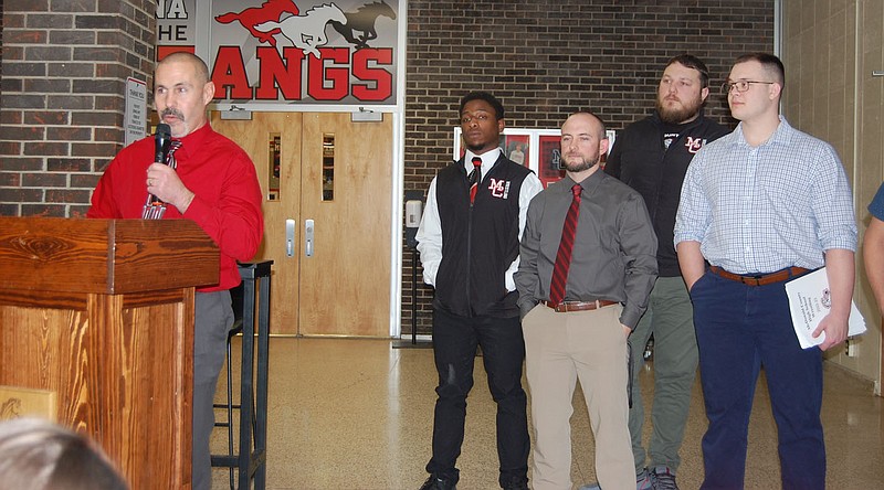 Bennett Horne/McDonald County Press McDonald County High School wrestling coach Josh Factor (left) introduces members of his coaching staff during the banquet held for winter sports on Monday at the high school cafeteria. The staff, made up of (from left) Joshua Tyler, Alan Callahan, Beau Bennett, Reid Davis and (not pictured) Oscar Ortiz, was named the top staff in the district, while Factor was named the district’s coach of the year.