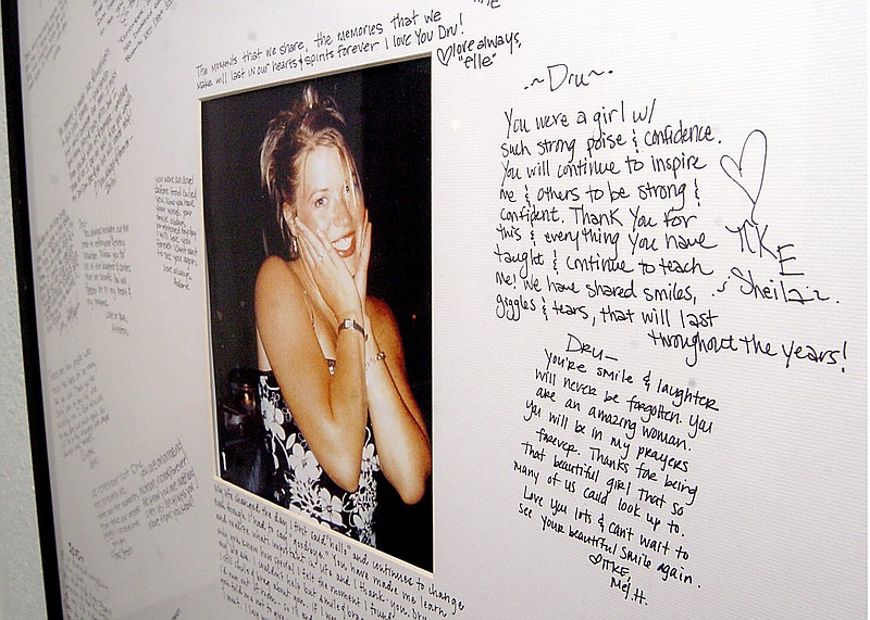 FILE - A memorial with a photo of Dru Sjodin and handwritten notes from fellow sorority members hangs in the entry of the Gamma Phi Beta house on the University of North Dakota campus in Grand Forks, N.D., Nov. 18, 2004. U.S. prosecutors said Tuesday, March 14, 2023, that they will no longer seek the death penalty for the man convicted in the kidnapping and killing of college student Sjodin in 2003 in a case that led to changes in sex offender registration laws. (AP Photo/Kory Wallen, File)