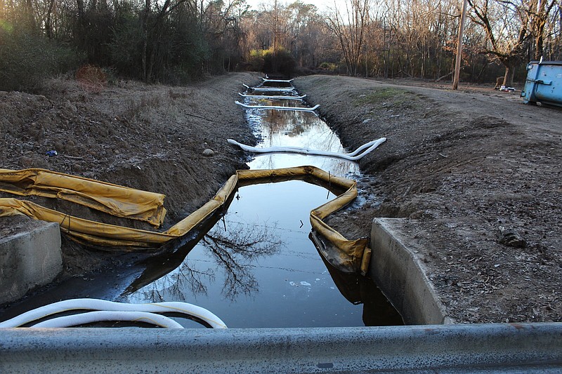 White piping could be seen across a concrete culvert part of water cleanup efforts along S. Walco Road near Kelly Street in Malvern, AR on Thursday, Jan. 5, 2023.