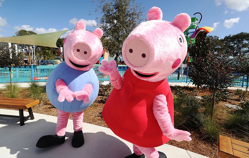 George and Peppa Pig characters pose during the media preview of Peppa Pig Theme Park, on Feb. 16, 2022. (Ricardo Ramirez Buxeda/Orlando Sentinel/TNS)