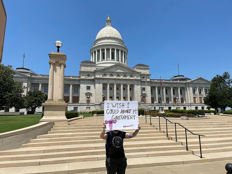 FILE - A demonstrator holds a sign outside the Arkansas state Capitol in Little Rock, Ark. on June 24, 2022, protesting the U.S. Supreme Court's decision overturning Roe v. Wade. A monument marking the number of abortions performed in Arkansas before Roe v. Wade was struck down would be built near the state Capitol under a bill lawmakers sent to Gov. Sarah Huckabee Sanders on Tuesday, March 14, 2023. (AP Photo/Andrew DeMillo, File)