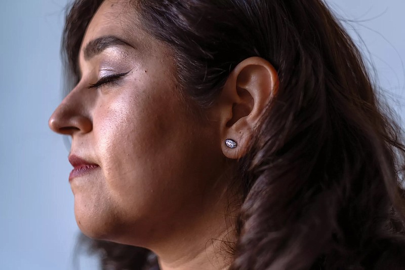 Rosa Valdes takes a breath while wearing her Xanax earrings. (Francine Orr/Los Angeles Times/TNS)