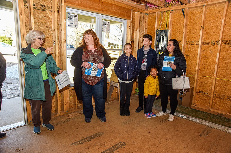 Julie Smith/News Tribune photo: 
Mary Schantz, vice president of the River City Habitat for Humanity Board of Directors, at left, introduces board members on hand for the Blessing of the Build at 803 Montana St. in Jefferson City on Wednesday, March 15, 2023. In addition, Shantz thanked the Jessica Holder family for taking part in the program and the Nichols Career Center Building Trades Class for their hard work on the project. Holder, at right, is joined by her children R'moni, Preston and Mia. Second from left is Susan Cook-Williams, executive director of RCHFH, who noted that this is the 129th Habitat house.