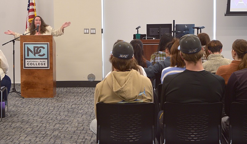 Laura Abbott gives the keynote address during an International Women's Day event at National Park College on March 15. Abbott was a victim of domestic abuse, and she advocates for other victims by telling her story and lobbying at the state Capitol. - Photo by Donald Cross of The Sentinel-Record