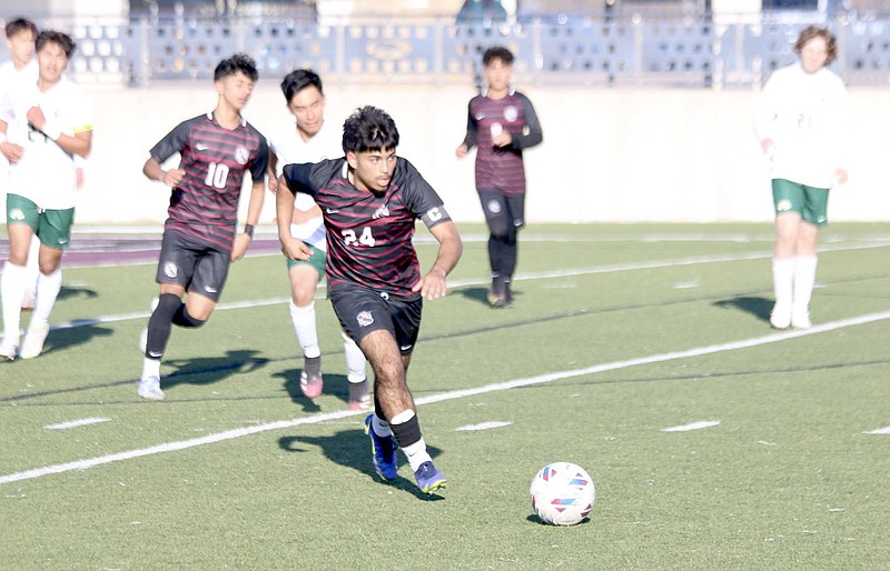 Mark Ross/Special to the Herald-Leader
Siloam Springs senior Ronald Mancia chases after a loose ball against Alma on March 14 at Panther Stadium. The Panthers defeated the Airedales 1-0.