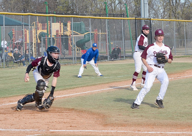 Graham Thomas/Herald-Leader
Siloam Springs catcher Landon Fain fields a ball in the infield as third baseman Andrew Pilcher and pitcher Ryder Winfrey close in on the play during a doubleheader against Mountain Home on March 14 at James Butts Baseball Complex. The Bombers swept the Panthers 12-1 and 5-3.