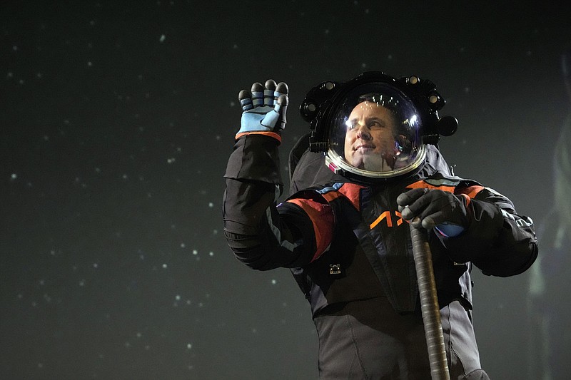 Axiom Space chief engineer Jim Stein demonstrates a prototype spacesuit Wednesday, March 15, 2023, in Houston. NASA selected Axiom Space to design the spacesuits that its moonwalking astronauts will wear when they step onto the lunar surface later this decade. (AP Photo/David J. Phillip)