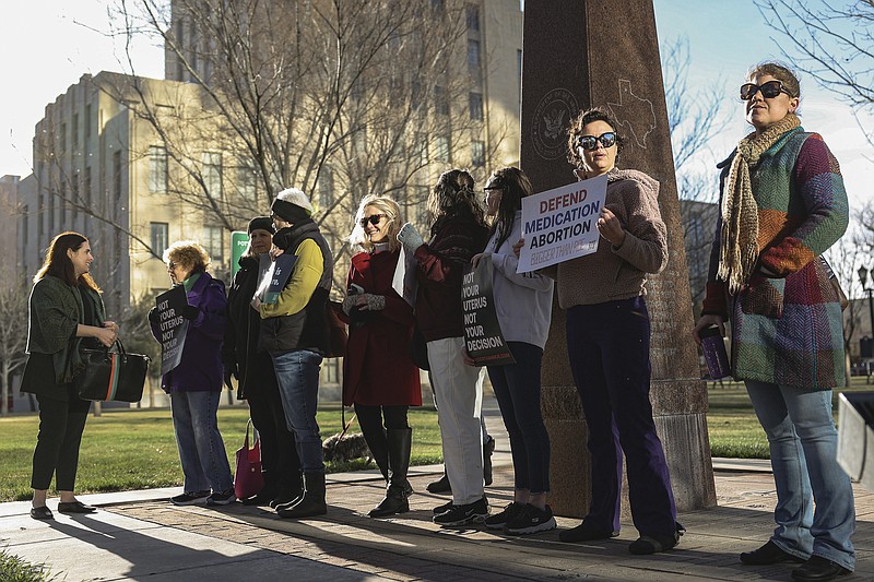 Women's March group protest in support of access to abortion medication outside the Federal Courthouse on Wednesday, March 15, 2023 in Amarillo, Texas. A conservative federal judge heard arguments Wednesday from a Christian group seeking to overturn the Food and Drug Administration’s more than 2-decade-old approval of an abortion medication, in a case that could threaten the most common form of abortion in the U.S. (AP Photo/David Erickson)