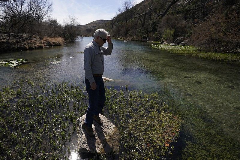 Rancher Randy Nunns overlooks the Devil's River near Del Rio, Texas, Thursday, Feb. 16, 2023. Nunns and fellow landowners along the Devil's River argue that proposed wind turbines would kill birds, bats and disrupt monarch butterflies migrating to Mexico and impact ecotourism, a main source of income for many. (AP Photo/Eric Gay)