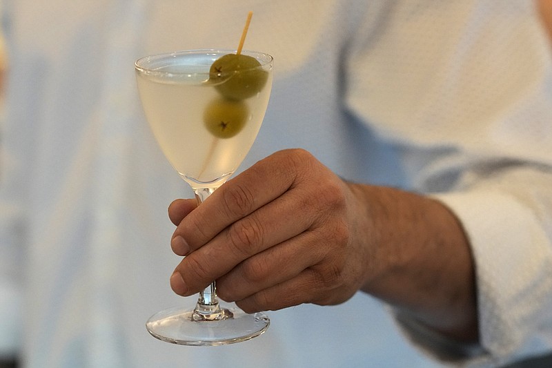 Bartender Brian McGee holds a Dirty Gin Martini with two olives at the Koval Distillery’s tasting room in Chicago. Spirits have surpassed beer for U.S. market share supremacy, according to the Distilled Spirits Council of the United States. (The Associated Press/Charles Rex Arbogast)