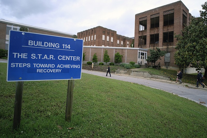 Visitors walk toward Building 114, the S.T.A.R. Center, at Central State Hospital on May 17, 2018, in Dinwiddie County, Va. Seven Virginia sheriff's office employees have been charged with second-degree murder in connection with the death of a 28-year-old man at Central State Hospital last week, a local prosecutor said Tuesday, March 14, 2023. (Bob Brown/Richmond Times-Dispatch via AP)