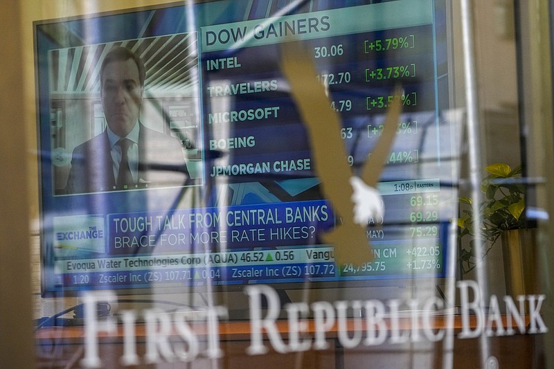 A television screen displaying financial news is seen inside one of First Republic Bank's branches in the Financial District of Manhattan, Thursday, March 16, 2023. The S&amp;P 500 was 0.8% higher in midday trading after erasing an earlier loss of nearly that much following reports that First Republic Bank could receive financial assistance or sell itself to another bank. (AP Photo/Mary Altaffer)