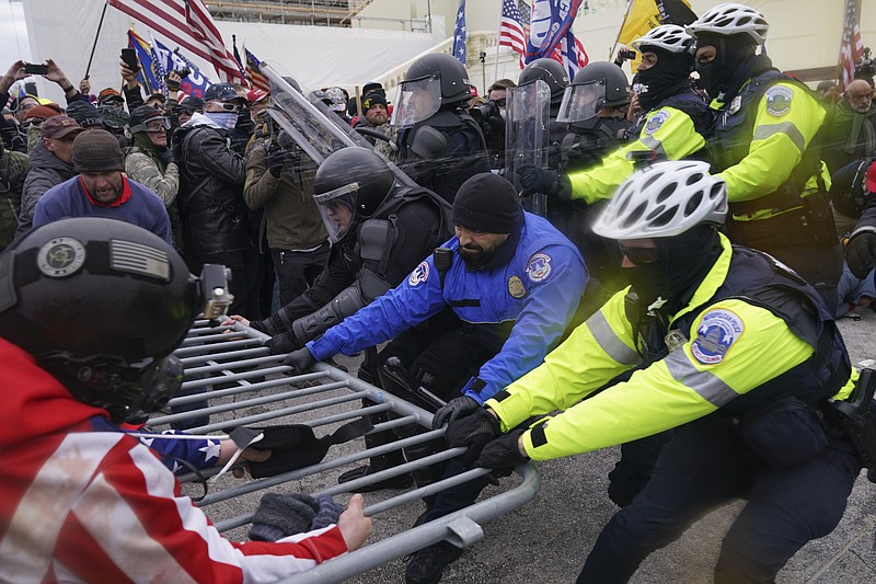 FILE - Rioters at the U.S. Capitol on Jan. 6, 2021, in Washington. A former top editor of an Orthodox Jewish newspaper in New York City was arrested Thursday on charges that he interfered with police officers who were trying to protect the U.S. Capitol during the Jan. 6 riot. Elliot Resnick, was chief editor of The Jewish Press when he joined the crowd of Donald Trump supporters who stormed the Capitol on Jan. 6, 2021, according to an FBI agent's affidavit. (AP Photo/John Minchillo, File)