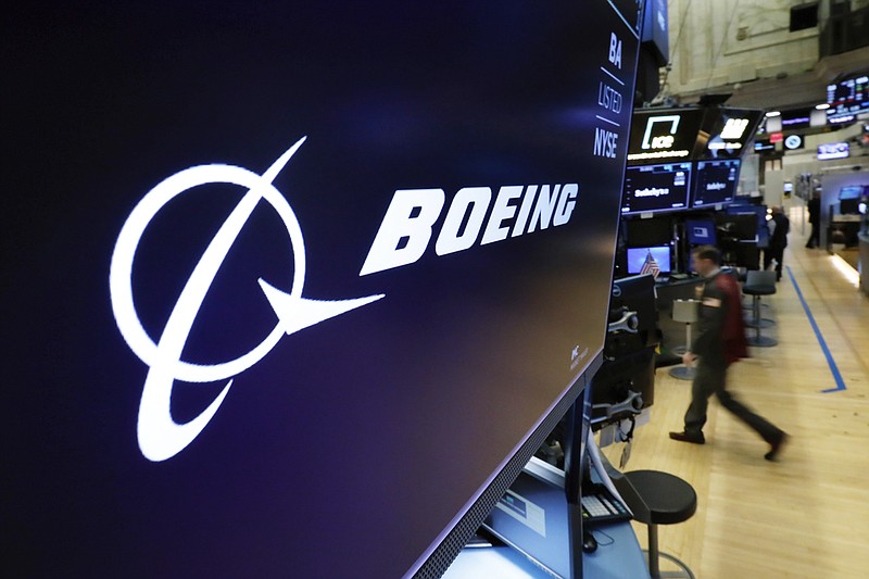 FILE - The Boeing logo appears above a trading post on the floor of the New York Stock Exchange on March 11, 2019. In a matter of days, Saudi Arabia carried out blockbuster agreements with the world's two leading powers, signing a Chinese-facilitated deal aimed at restoring diplomatic ties with its arch-nemesis Iran and announcing a massive contract to buy commercial planes from U.S. manufacturer Boeing.(AP Photo/Richard Drew, File)