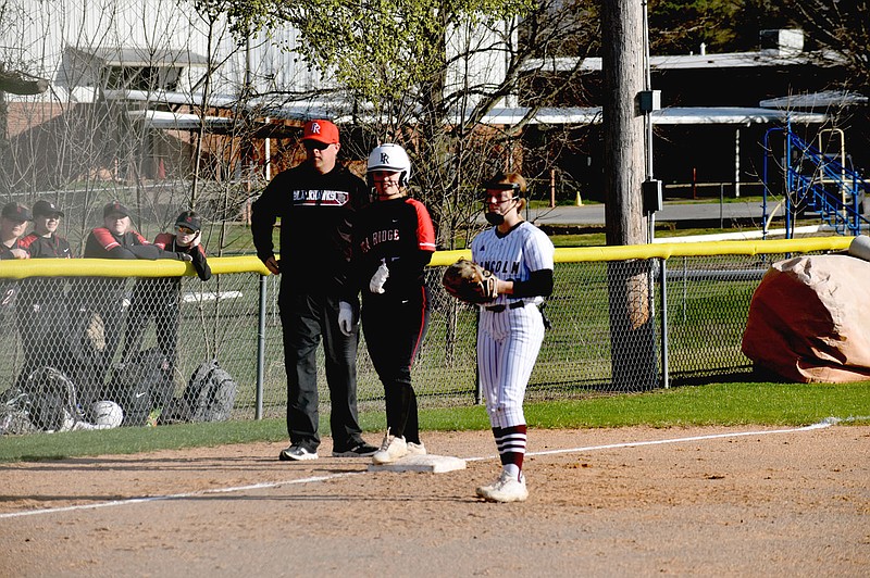 Mark Humphrey/Enterprise-Leader
Pea Ridge head softball coach Josh Reynolds confers with junior Callie Cooper stationed at third behind Lincoln infielder Amber Bryant. Pea Ridge defeated Lincoln, 10-0, in a run-rule shortened nonconference softball game that lasted five innings on Tuesday, March 14, 2023.