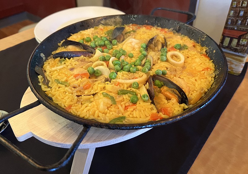Calamari, shrimp, clams, mussels and chicken, along with plentiful rice, made up the Friday seafood paella special at Mi Paella. (Arkansas Democrat-Gazette/Eric E. Harrison)