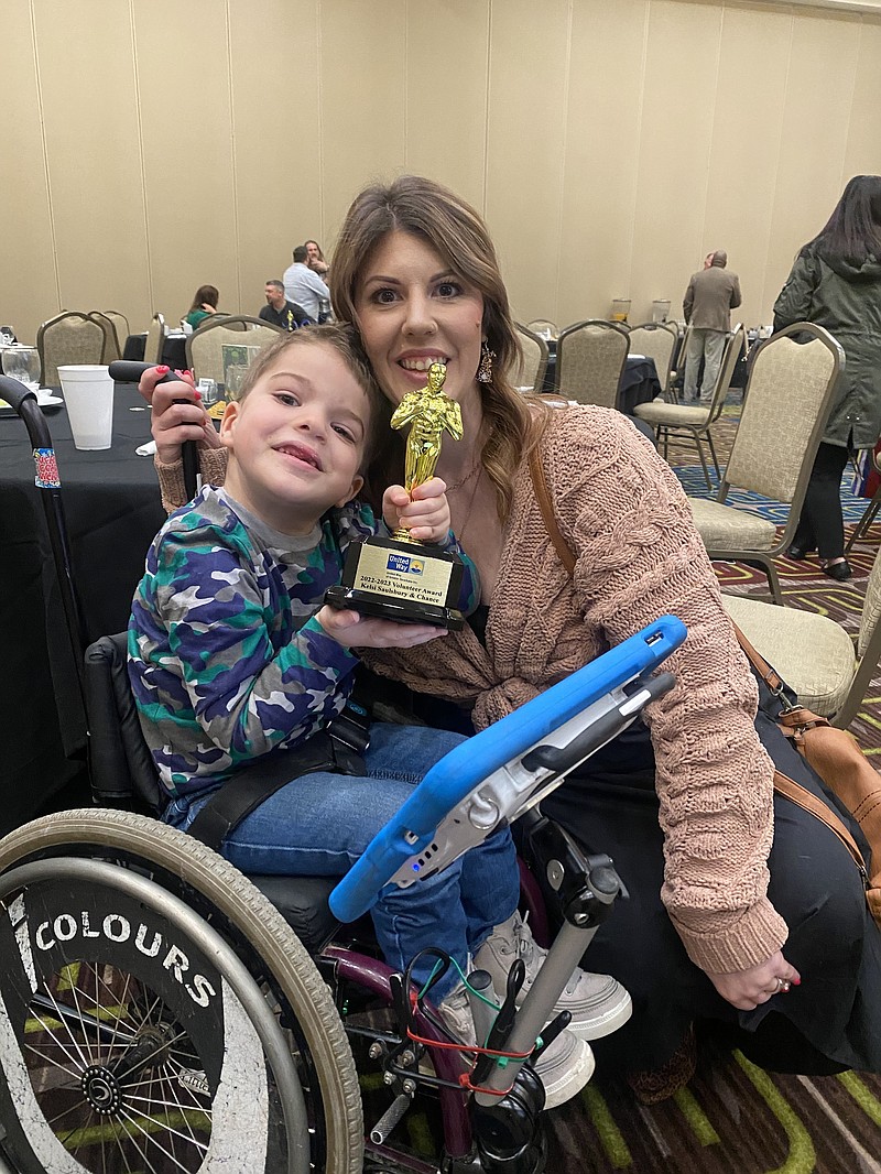 Chance Saulsbury, 6, left, and his mother, Kelsi Saulsbury, pose with the Volunteer Award presented by the United Way of Greater Texarkana during the agency's Recognition Breakfast on Friday, March 17, 2023, at Texarkana Convention Center on the Texas side. Chance, who is a client at Temple Memorial Pediatric Center, is featured in the United Way's campaign video. (Staff photo by Sharda James)