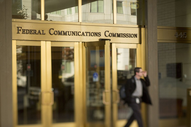 A man walks out of the Federal Communications Commission headquarters in this photo taken with a tilt-shift lens in Washington, D.C. (Bloomberg photo by Andrew Harrer)