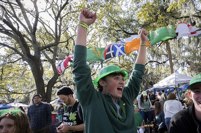 Jack Stephans cheers while watching the St. Patrick's Day parade from the crowded oak-shaded square, Friday, March 17, 2023, in historic downtown Savannah, Ga. (AP Photo/Stephen B. Morton)