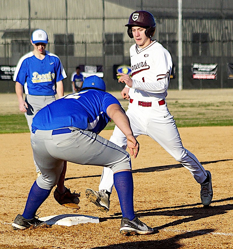 Randy Moll/Westside Eagle Observer
Decatur third baseman Brandon Montano tags third base ahead of Owen Foreman for an out during play between the Bulldogs and the Pioneers in Gentry on March 14.