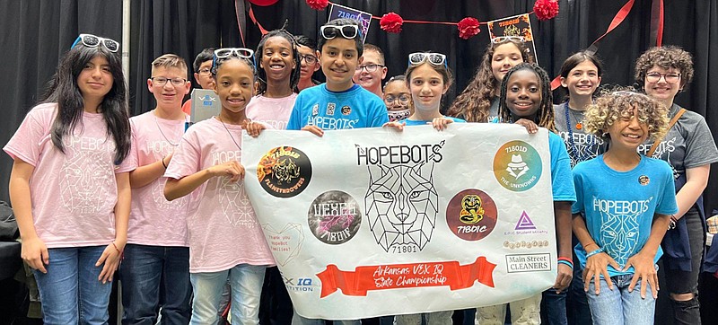 Three HopBots teams pose with their banner after the recent Arkansas VEX IQ State Championships in Russellville. In no particular order are The Vexes of E’Mahree Muldrew, Jazlyn Mejia, Samuel Fellows and Rey Mendoz; The Flamethrowers of Kayveon Anderson, Ella Bramlett, Graydon Randle and Johnny Paredes; The Cobra Kais of Julia Bobo, Sophia Finigan and Aracely Garcia; and The Unknowns of Ramsey Beck, Kevin Bran, Terrianna Frazier and Julian Ugarte. The Vexes and Flamethrowers advanced to the world championships April 24 to May 5 in Dallas. (Submitted photo)