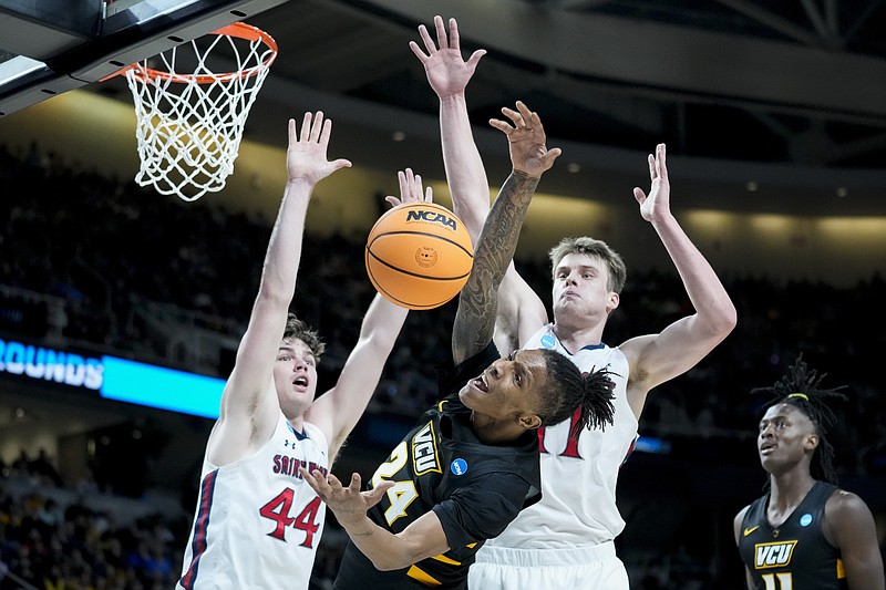Virginia Commonwealth's Nick Kern (24) battles for a rebound against St. Mary's Alex Ducas (44) in the first half of a first-round college basketball game in the NCAA Tournament, Friday, March 17, 2023, in Albany, N.Y. (AP Photo/John Minchillo)