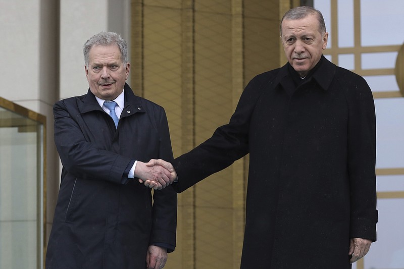 Turkish President Recep Tayyip Erdogan, right, and Finland's President Sauli Niinisto shake hands during a welcome ceremony at the presidential palace in Ankara, Turkey, Friday, March 17, 2023. Erdogan greeted his Finnish counterpart in Ankara on Friday amid hopes that their meeting will see Turkey approve Finland's NATO membership bid. (AP Photo/Burhan Ozbilici)