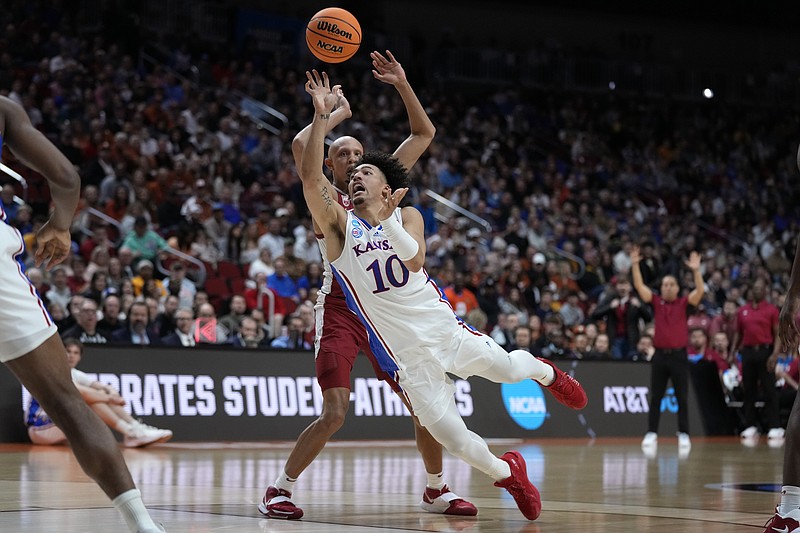 Kansas forward Jalen Wilson shoots in front of Arkansas guard Jordan Walsh, rear, in the second half of a second-round college basketball game in the NCAA Tournament, Saturday, March 18, 2023, in Des Moines, Iowa. (AP Photo/Charlie Neibergall)