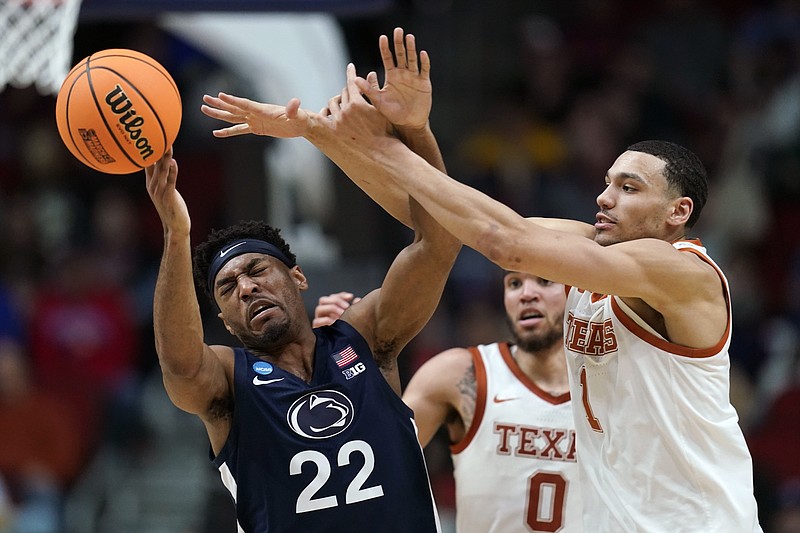 Penn State guard Jalen Pickett (22) is fouled by Texas forward Dylan Disu (1) in the first half of a second-round college basketball game in the NCAA Tournament, Saturday, March 18, 2023, in Des Moines, Iowa. (AP Photo/Charlie Neibergall)